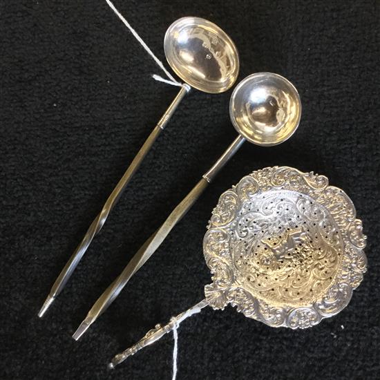 2 Georgian small silver toddy ladles and a Dutch embossed whit metal tea strainer with eagle hook handle